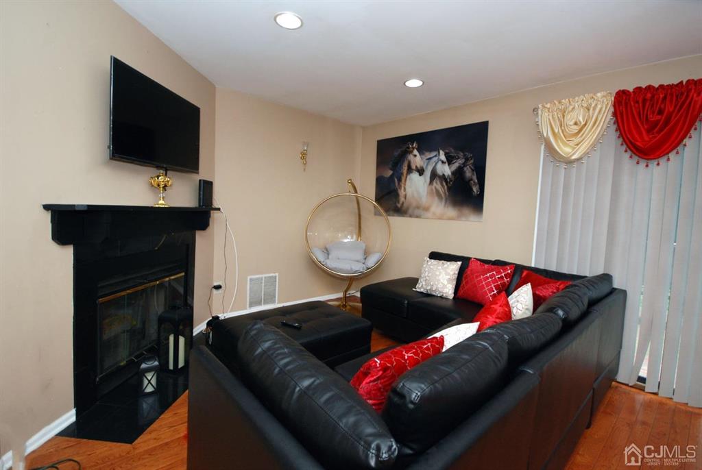2 Tulip Court Edison, NJ 08820 - Photo 9 of 34 a living room with furniture and a flat screen tv