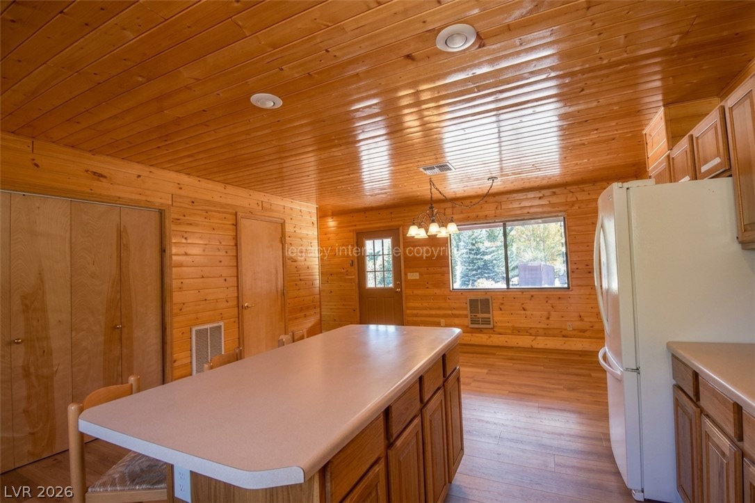 1129 East Ponderosa Road Hatch, UT 84735 - Photo 11 of 47 Warm wood paneling wraps from the walls to the ceiling in this inviting kitchen space.