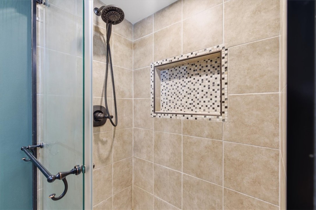112 Newry Road Seneca, SC 29672 - Photo 14 of 19 This sleek shower features a mosaic-tiled niche, offering both style and functionality.