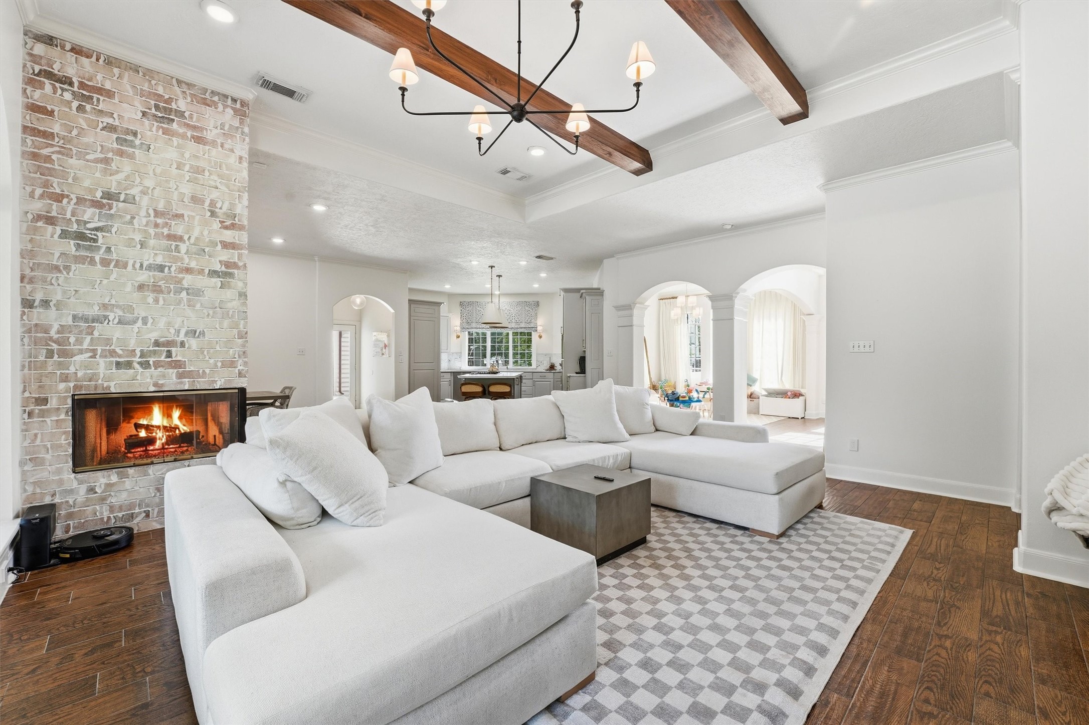 23210 Willowcreek Stables Road Spring, TX 77389 - Photo 7 of 45 Wood beams, classic arch ways and a cozy fireplace in the living & dining areas.
