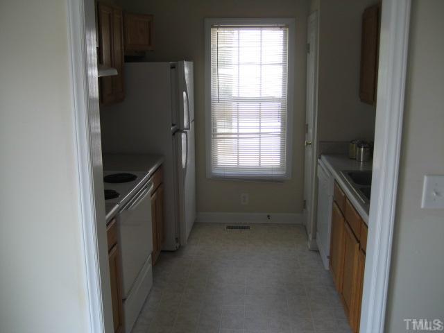 3201 Stedman Drive Raleigh, NC 27607 - Photo 3 of 7 a kitchen with a refrigerator and a stove