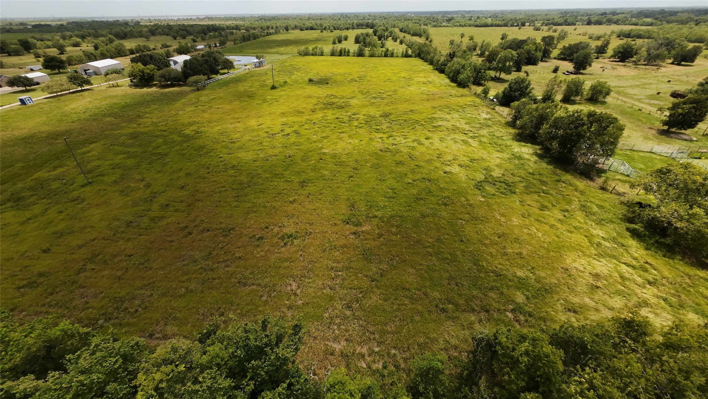 Aerial view, property goes past the first tree line. Ample room for building.