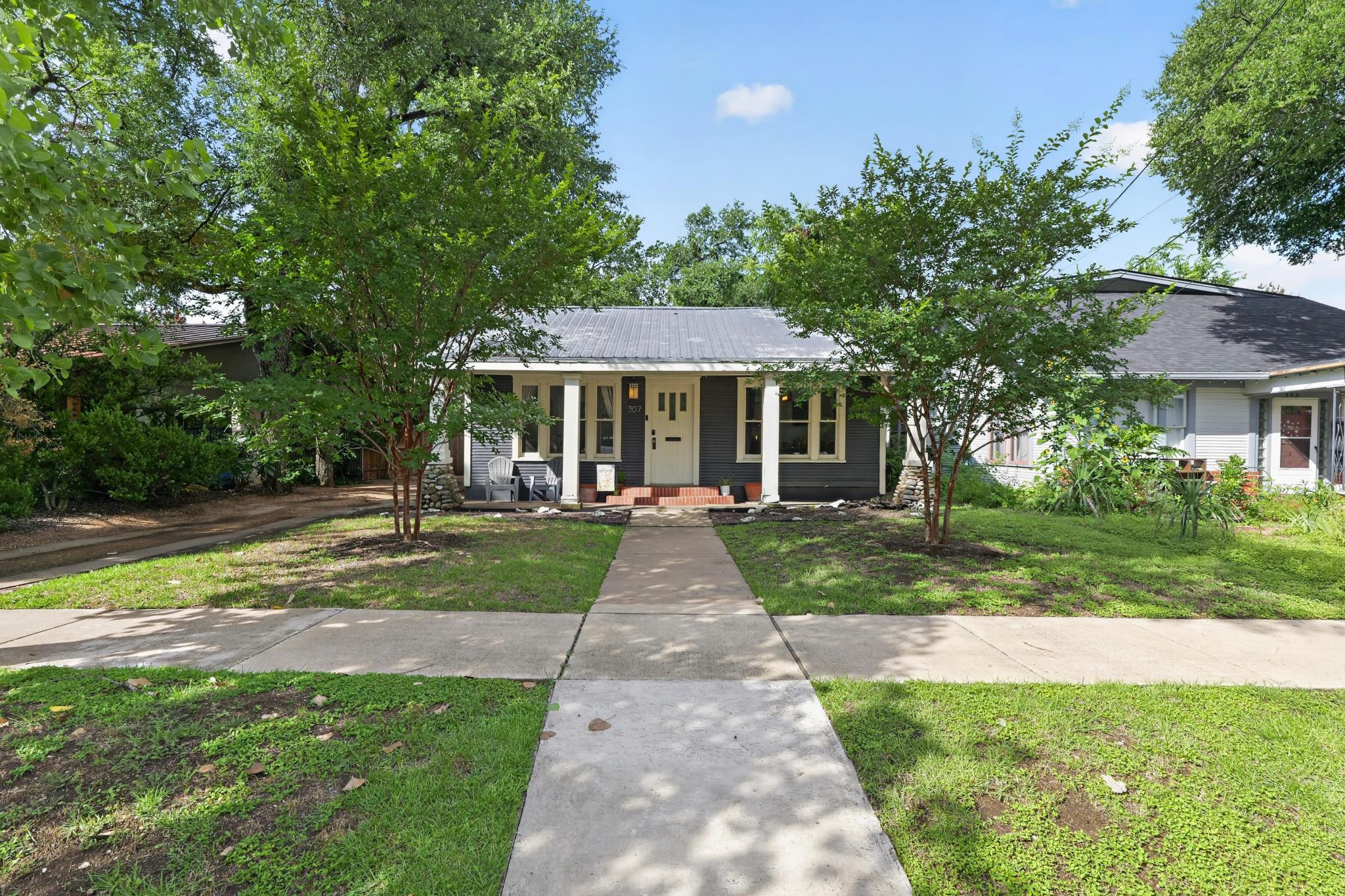307 East 35th Street, Unit A Austin, TX 78705 - Photo 6 of 40 A charming single-level residence featuring a welcoming porch and well-maintained front yard.