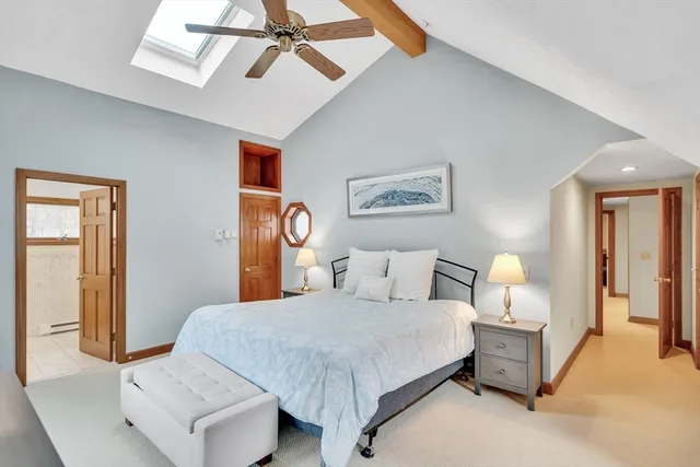 a bedroom with a bed and lamp