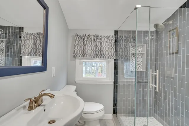 a bathroom with a sink toilet and shower