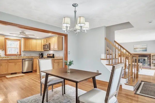 a view of a dining room with furniture a chandelier and wooden floor