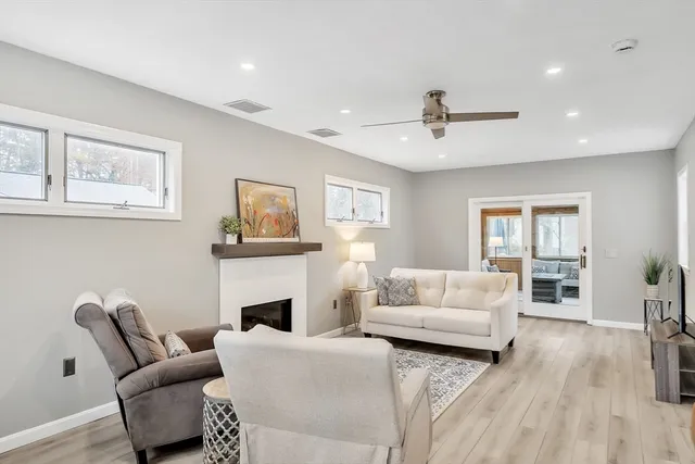 a living room with furniture a fireplace and a flat screen tv