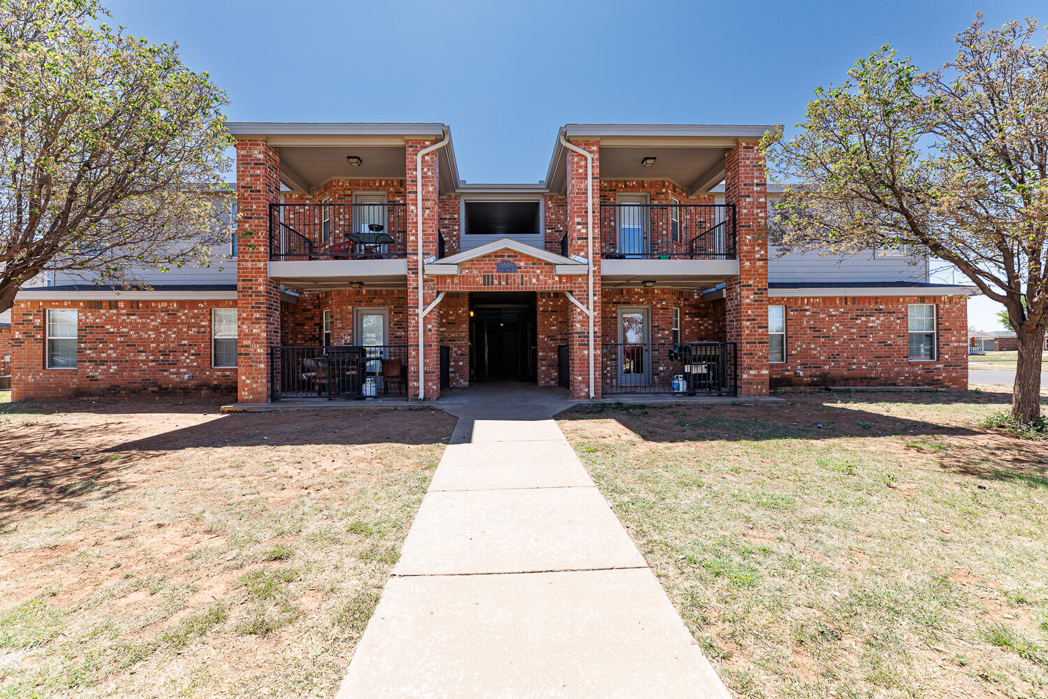 5845 7th Street Lubbock, TX 79416 - Photo 1 of 8 a front view of building with yard