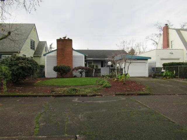 a front view of a house with a garden and yard