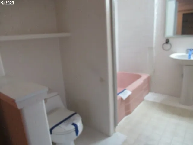 a bathroom with a bathtub sink and toilet