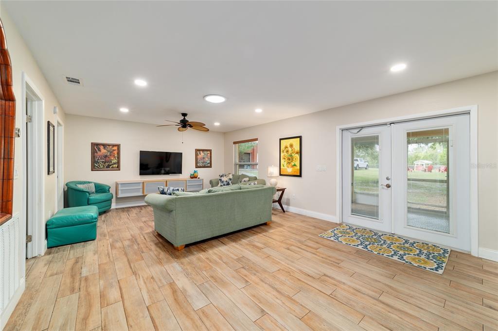 16520 Northwest 170th Street Williston, FL 32696 - Photo 17 of 98 a living room with furniture and a wooden floor