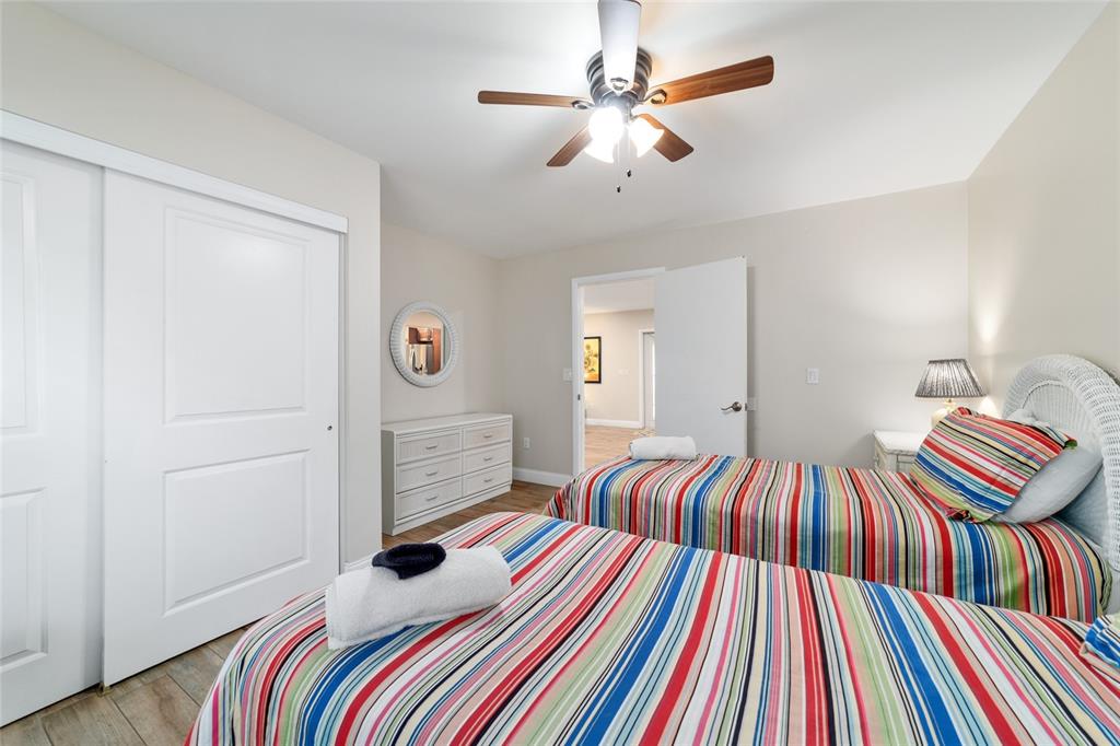 16520 Northwest 170th Street Williston, FL 32696 - Photo 30 of 98 a bedroom with a bed and a chandelier