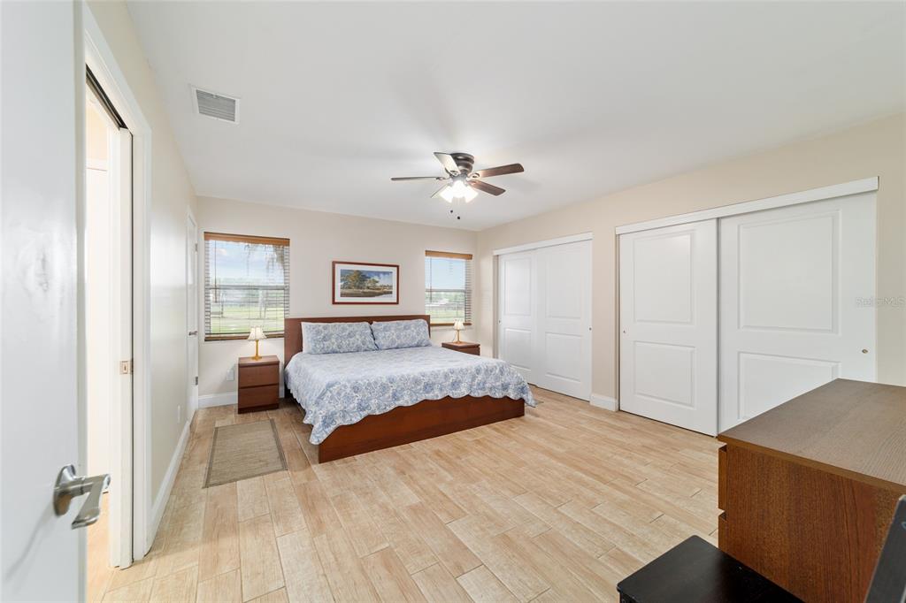 16520 Northwest 170th Street Williston, FL 32696 - Photo 53 of 98 a spacious bedroom with a large bed and a chandelier