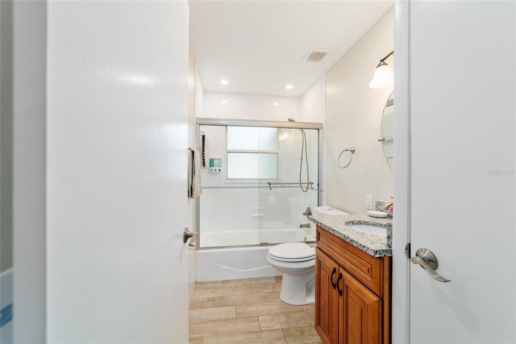 16520 Northwest 170th Street Williston, FL 32696 - Photo 60 of 98 a bathroom with a granite countertop sink mirror vanity and toilet