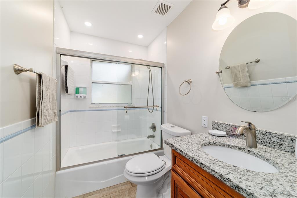 16520 Northwest 170th Street Williston, FL 32696 - Photo 61 of 98 a bathroom with a granite countertop sink toilet a mirror and shower