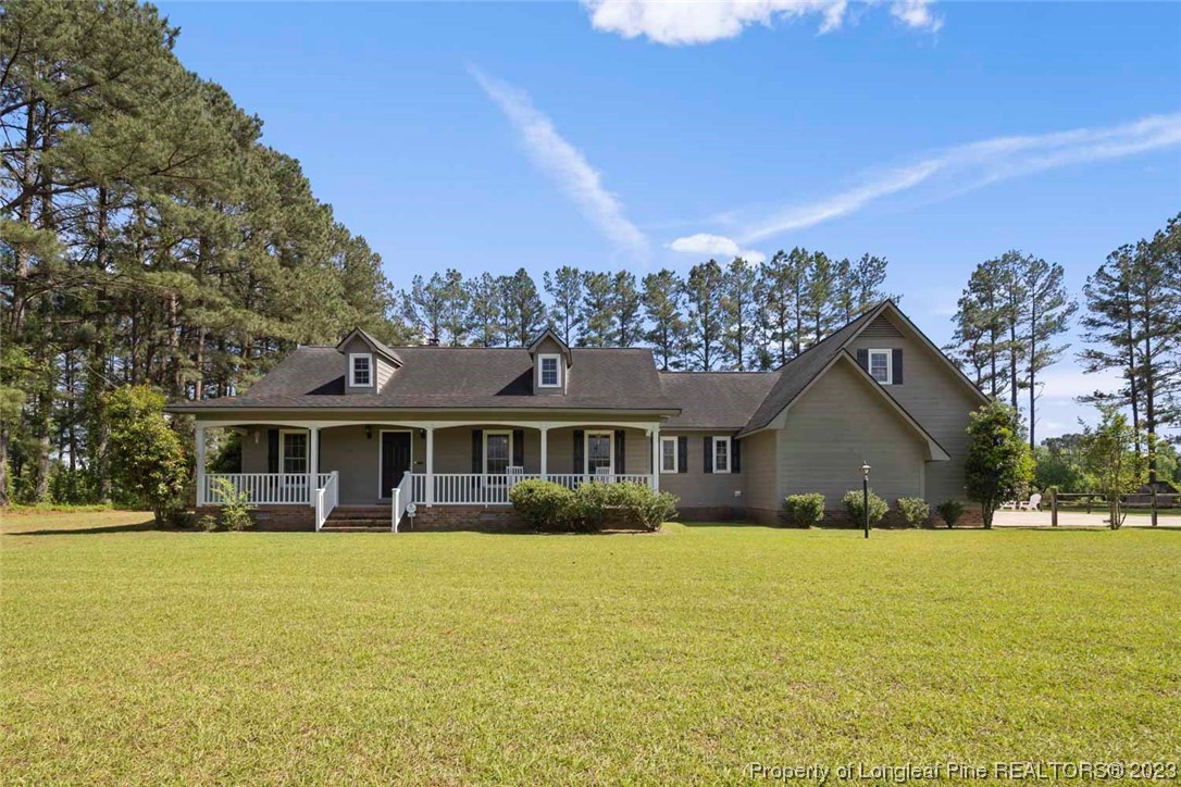 2451 Turnpike Road Raeford, NC 28376 - Photo 1 of 32 a front view of a house with a yard