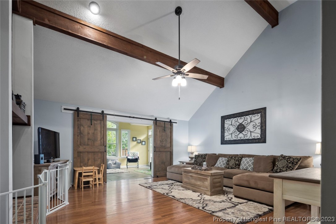 2451 Turnpike Road Raeford, NC 28376 - Photo 22 of 32 a living room with furniture and a wooden floor
