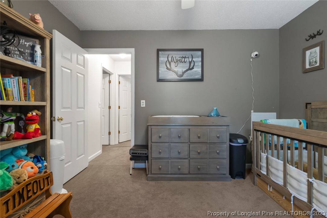 2451 Turnpike Road Raeford, NC 28376 - Photo 27 of 32 a room with a baby crib and a dresser