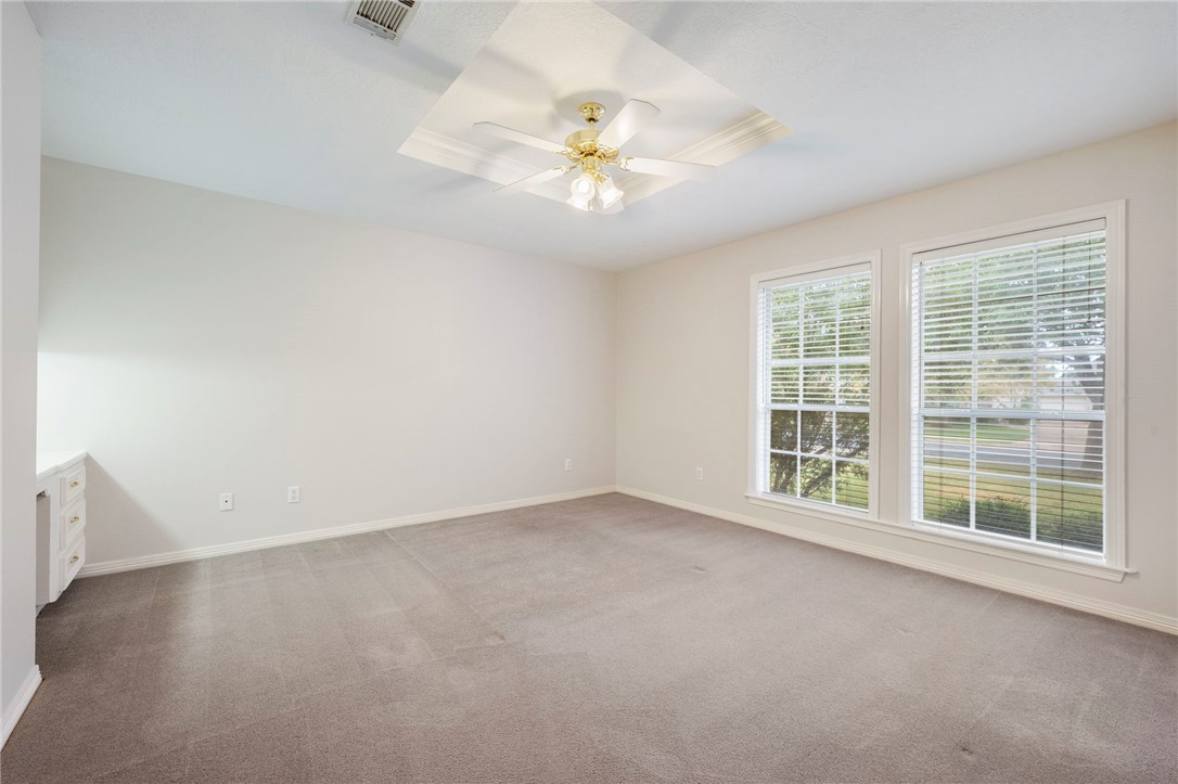 713 Willow Loop College Station, TX 77845 - Photo 21 of 39 an empty room with chandelier fan and windows