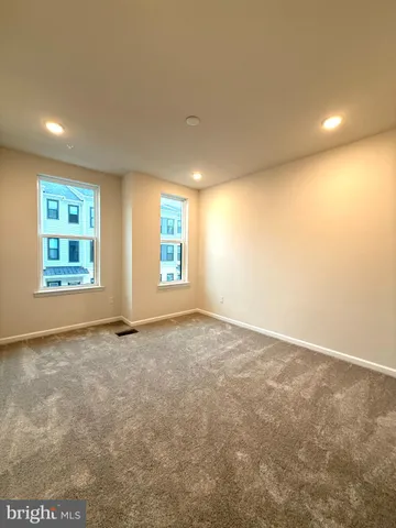 a spacious bathroom with a double vanity sink a mirror and a bathtub