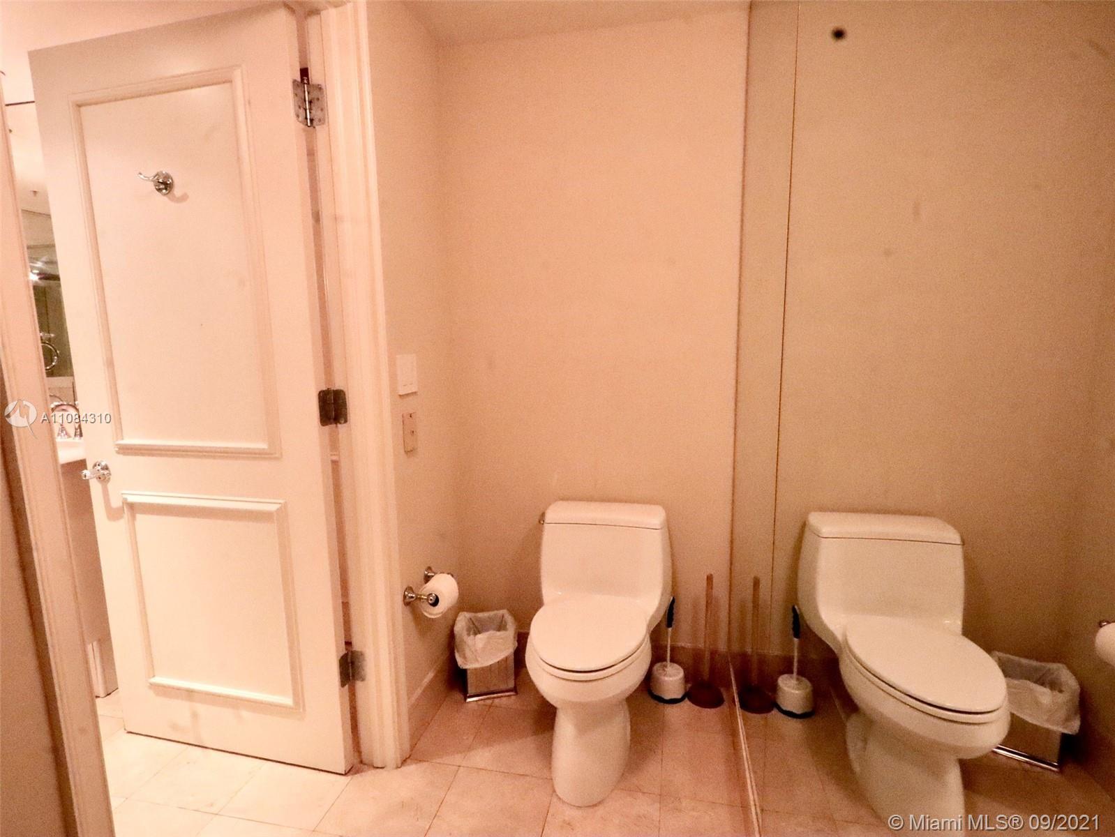 The Grove Coconut Grove, FL 33133 - Photo 17 of 31 a white toilet sitting next to a shower