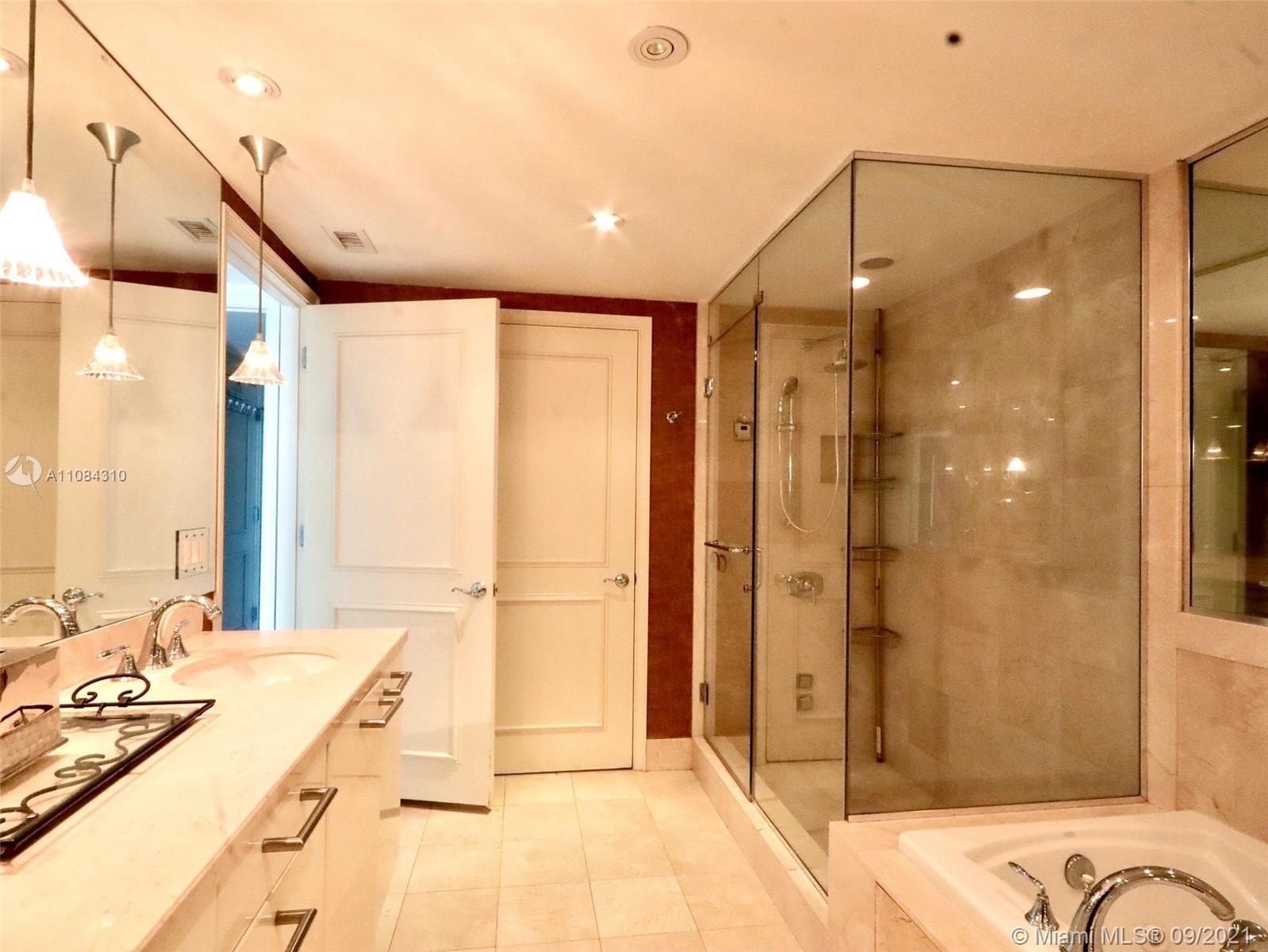 The Grove Coconut Grove, FL 33133 - Photo 18 of 31 a bathroom with a double vanity sink and mirror