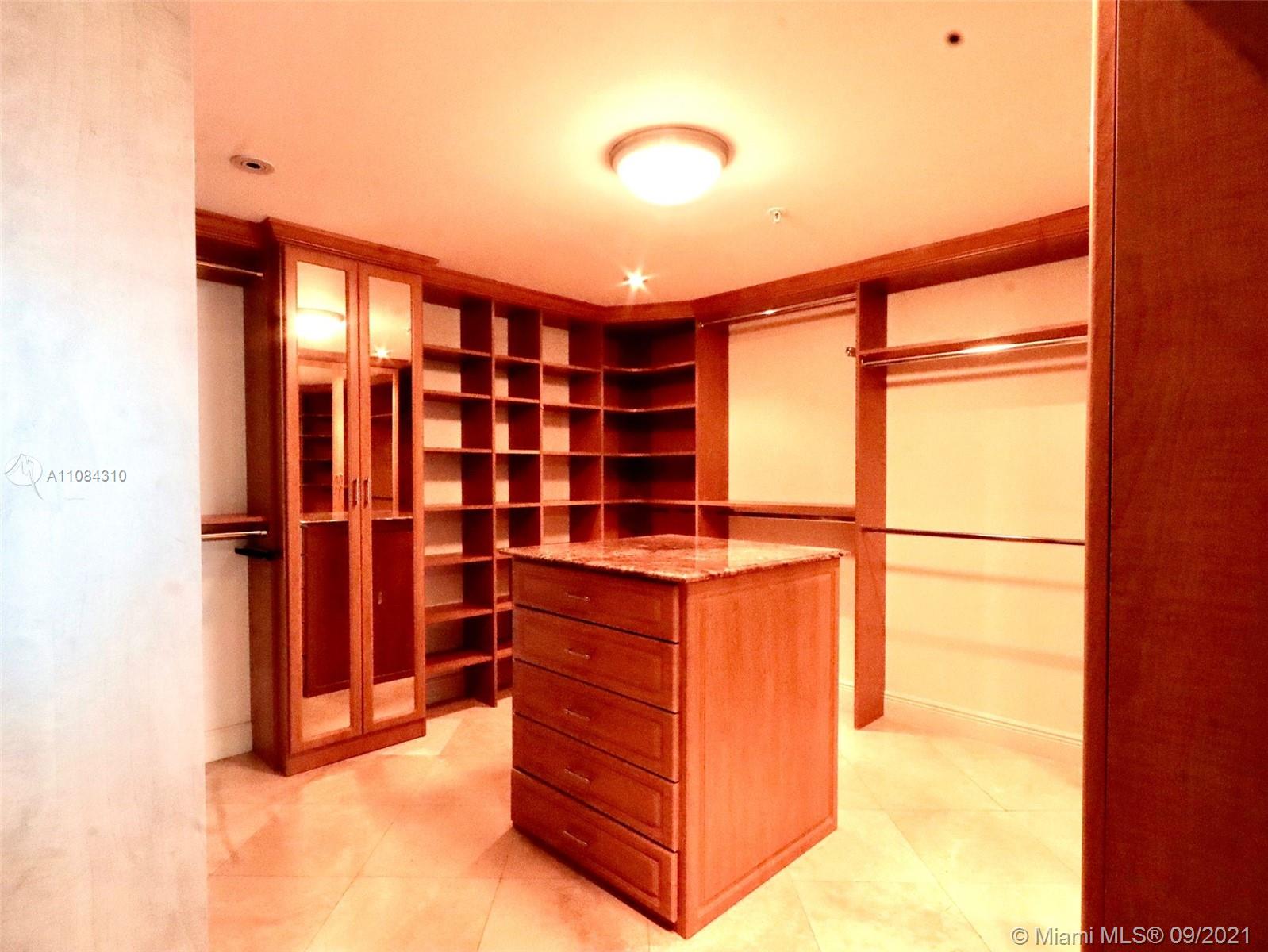 The Grove Coconut Grove, FL 33133 - Photo 22 of 31 a view of walk in closet with clothes and shoes
