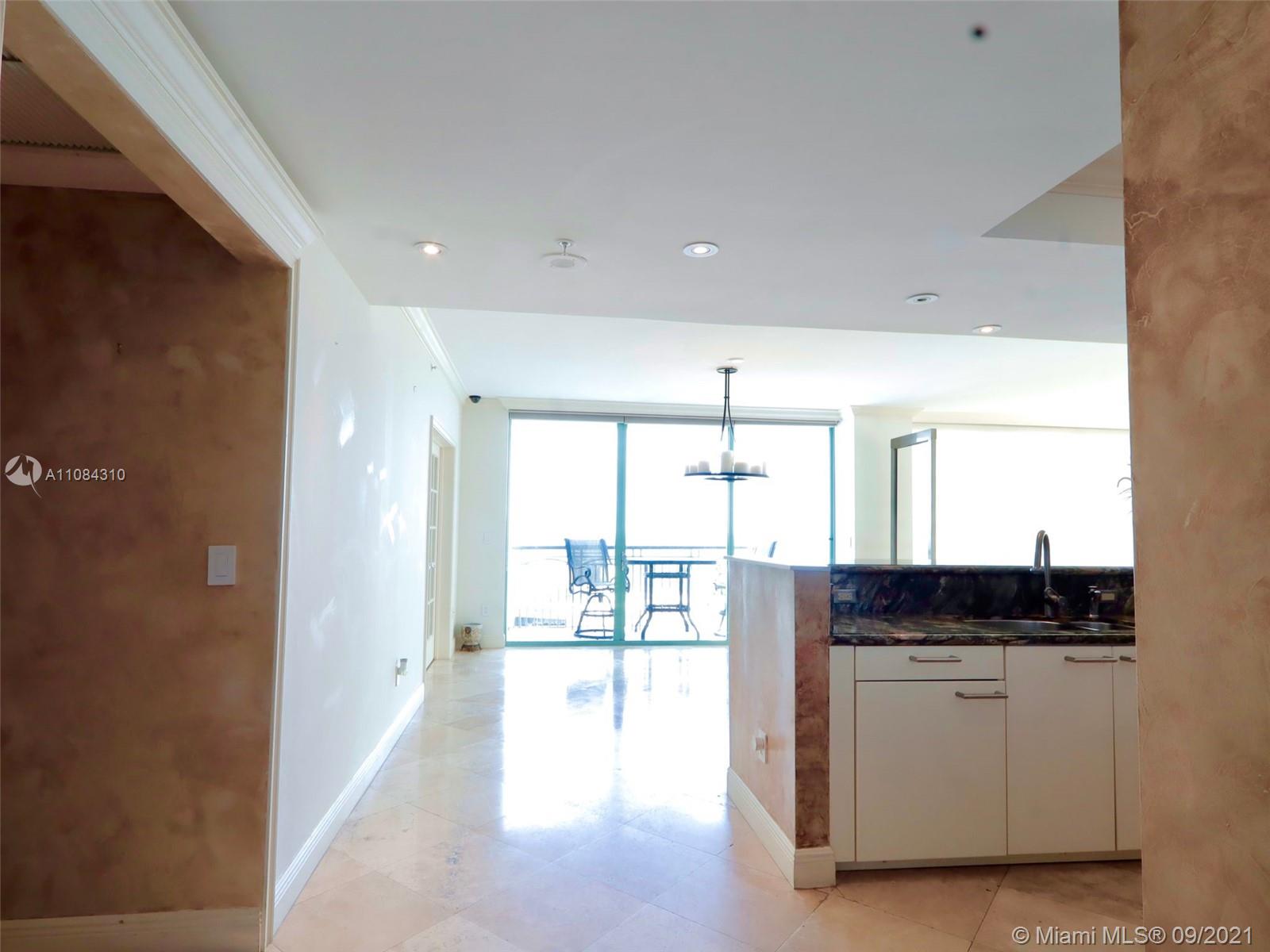 The Grove Coconut Grove, FL 33133 - Photo 30 of 31 a view of open kitchen with a sink and dishwasher a stove with wooden floor