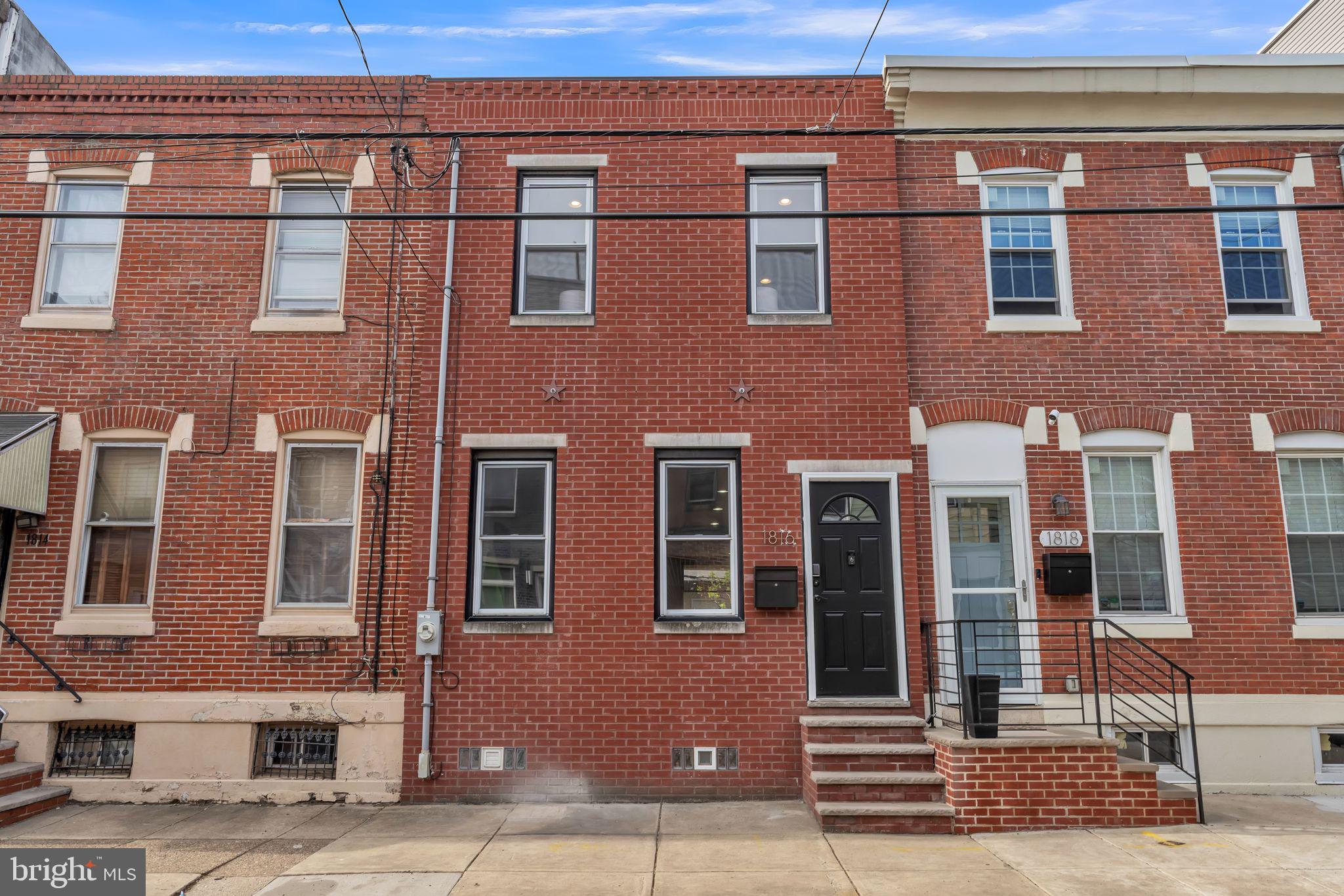 1816 Reed Street Philadelphia, PA 19146 - Photo 1 of 30 a front view of a building with a yard