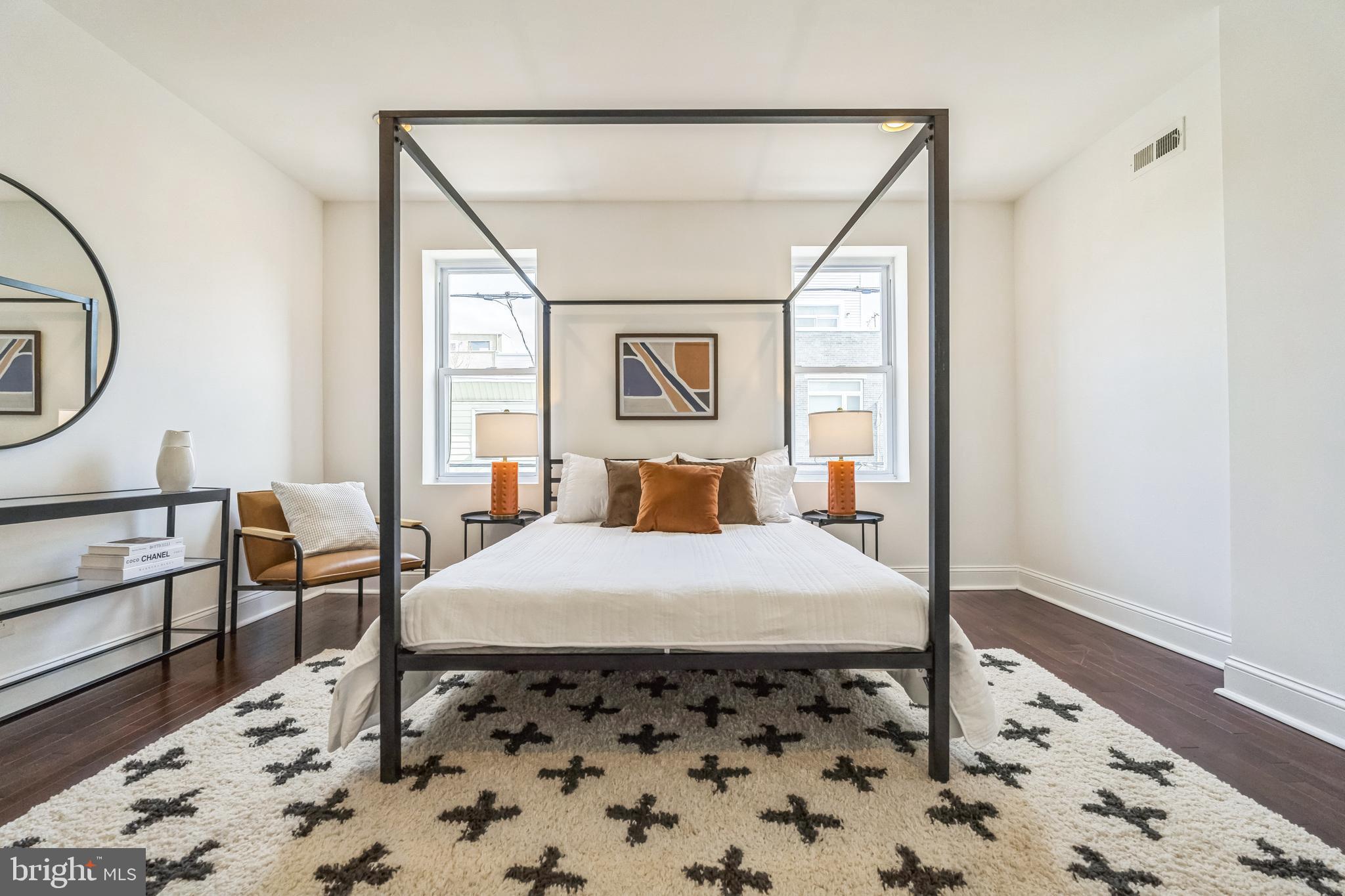 1816 Reed Street Philadelphia, PA 19146 - Photo 16 of 30 a bedroom with a bed and wooden floor