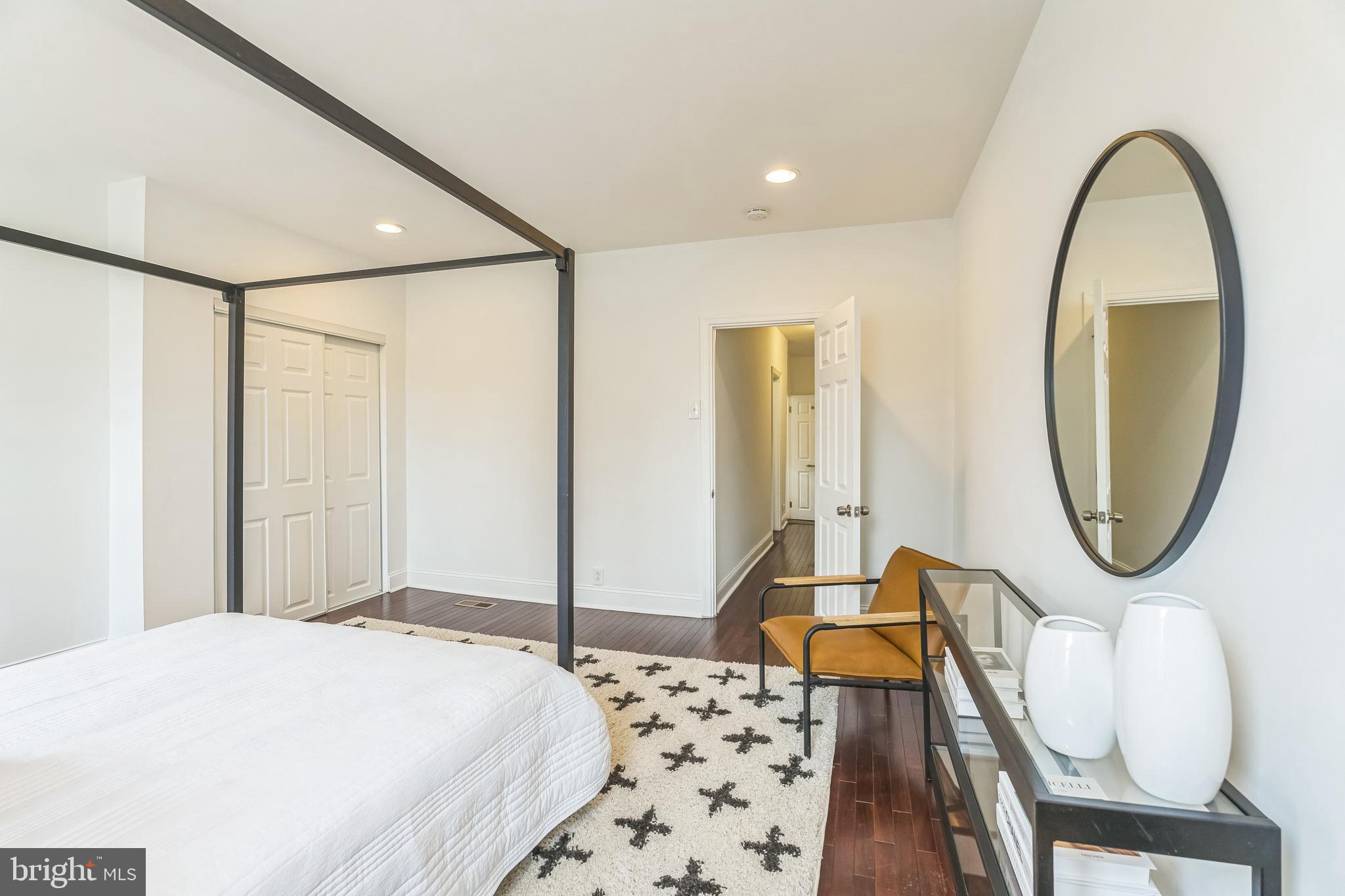 1816 Reed Street Philadelphia, PA 19146 - Photo 18 of 30 a bedroom with bed and a mirror