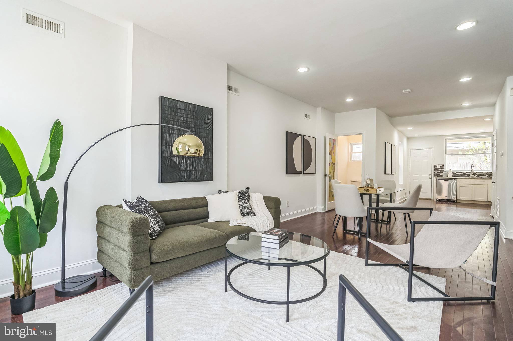 1816 Reed Street Philadelphia, PA 19146 - Photo 5 of 30 a living room with furniture potted plant and white walls