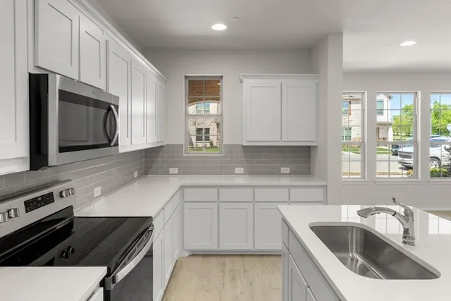 a kitchen that has a sink and a stove