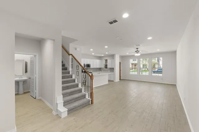 a view of entryway and hall with wooden floor