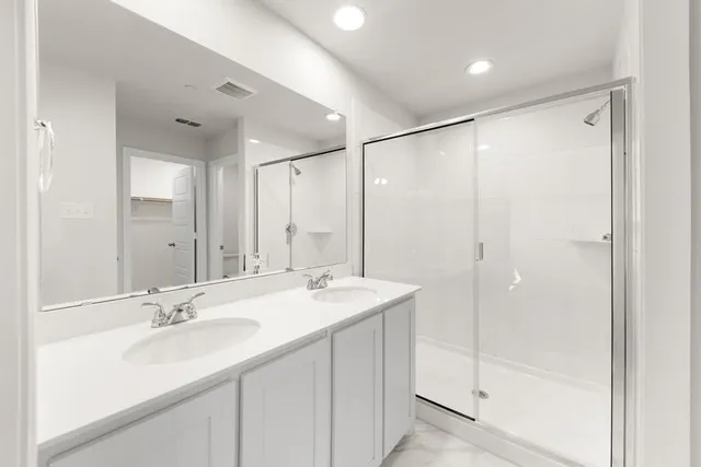 a bathroom with a shower sink double and mirror