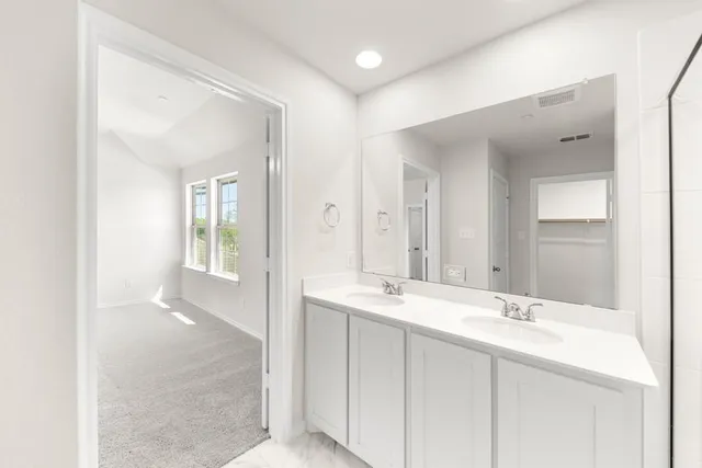 a bathroom with 2 sink and a mirror