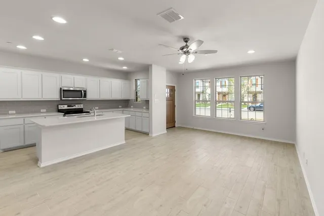 a view of a kitchen with electric appliances