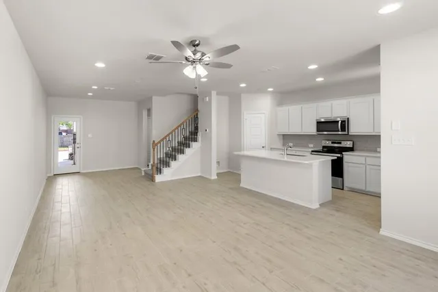 a view of kitchen with microwave and cabinets