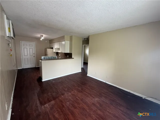 a view of a kitchen with wooden floor and a sink