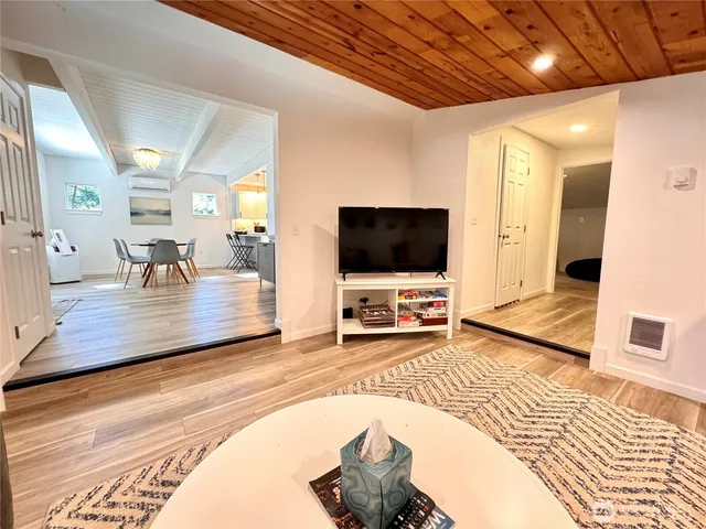 a living room with a flat screen tv and a table