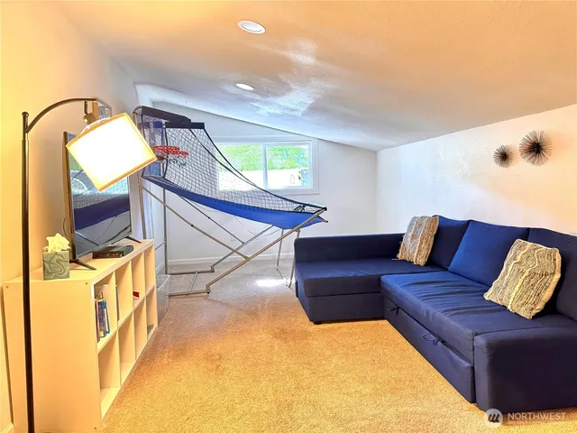 a living room with furniture and a mirror