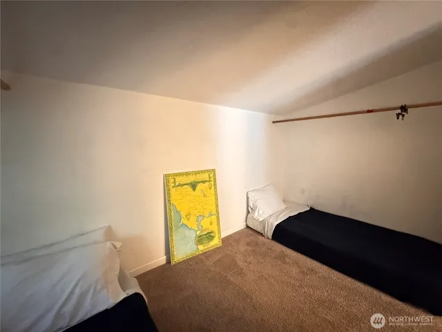 a bedroom with a bed and a wall painting