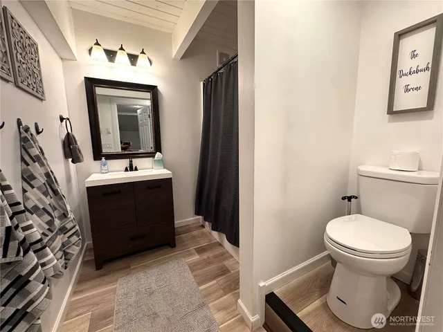 a bathroom with a toilet sink and mirror