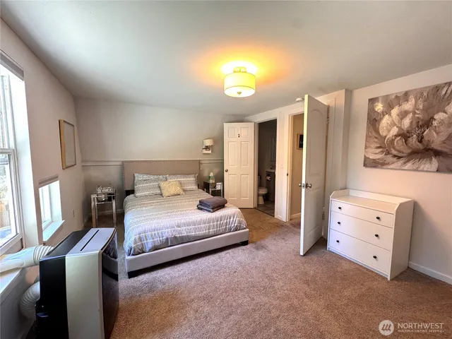 a bedroom with a bed and a window