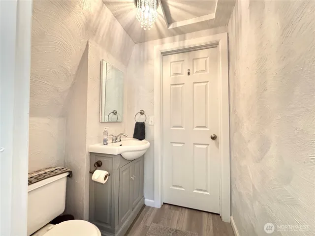 a bathroom with a sink a toilet a mirror and shower