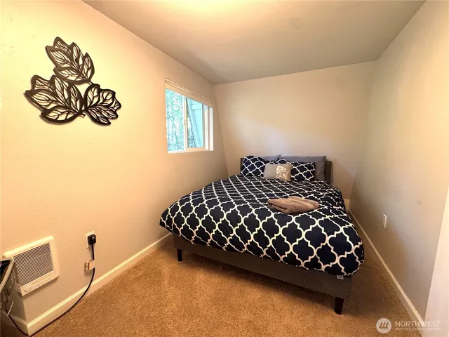 a bed sitting in a bedroom next to a window