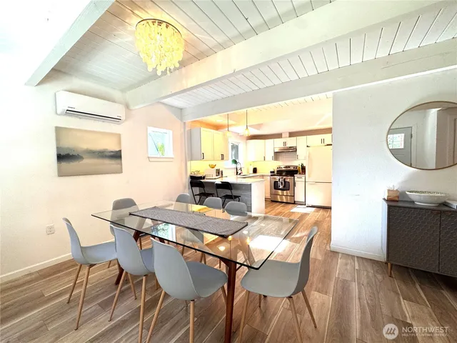 a view of a dining room with furniture and a chandelier