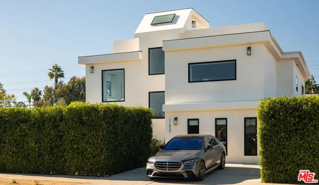 a car parked in front of house with a yard