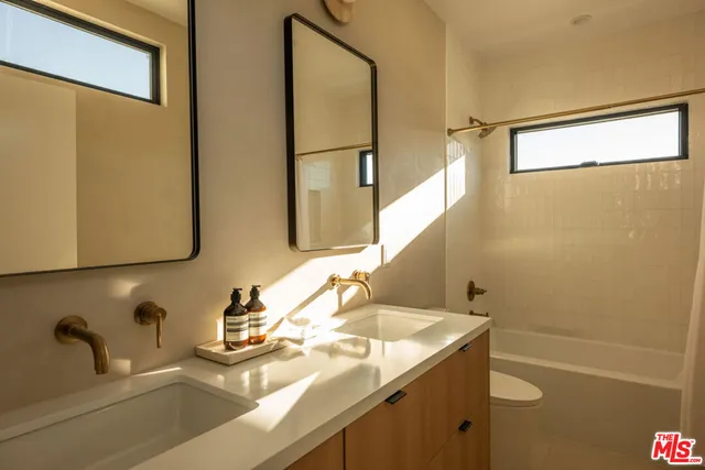 a view of a chair and table in the back yard of the house
