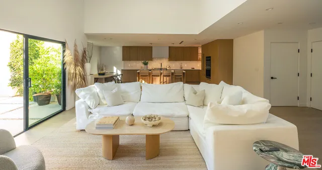 a kitchen with kitchen island granite countertop a sink and cabinets